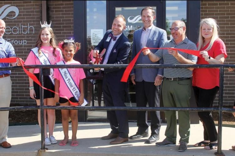 Members of the El Reno Chamber of Commerce gather as Dr. Kevin Lewis cuts the ceremonial ribbon outside the SSM Saint Anthony’s Clinic.