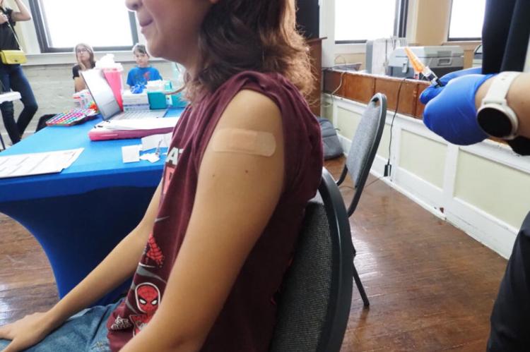 A nurse vaccinates a child at the Latino Community Development Agency in Oklahoma City