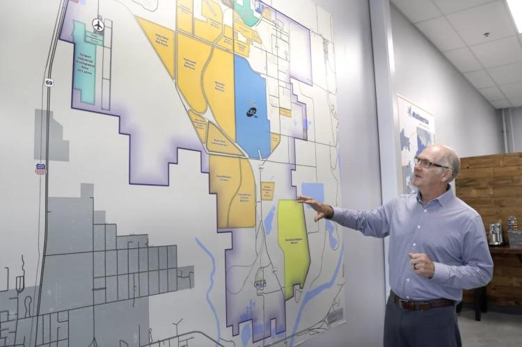 Dave Stewart gestures toward a map