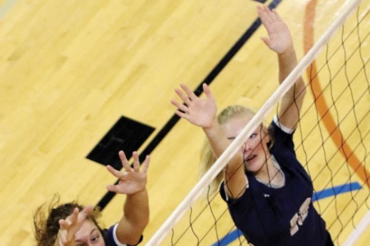 El Reno High School volleyball players Jennis Goucher (4) and Avery Peffer (19) watch the ball sail wide of their double block attempt during the recent El Reno Invitational. Both players had at least one kill in the win over Tuttle.