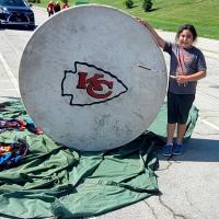George Levi’s youngest son, Able, poses with the drum