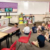 Emily O’Hara’s kindergarten class listens as she talks about school procedures