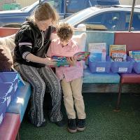 Amanda and Asher Blanton look through a book
