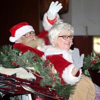 Santa and Mrs. Claus wave