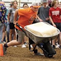 Carson Cooper makes a quick turn during the wheelbarrow race