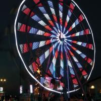 The Ferris wheel from Great Plains Amusement lights up the night sky