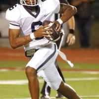 Elijah Fisher rolls out of the pocket on a pass play