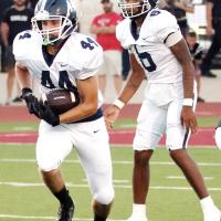 Grant First runs after taking a handoff from Elijah Fisher