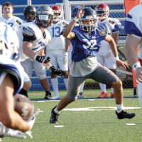 William Elledge shakes off a blocker as he tries to make his way back across the field