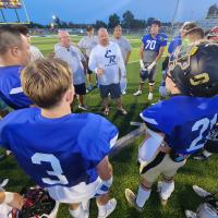 Russell Cook talks with West team members, including EHS’ Dion Kaulaity