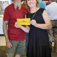 Amanda Meyer and husband, Richard hold up their tickets