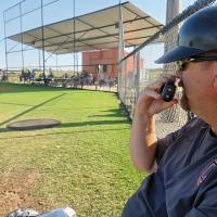 Cody Thiessen uses a walkie-talkie to call pitches to catcher Wade Reed