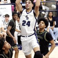 Tre Davis (24) jumps between two Midwest City defenders
