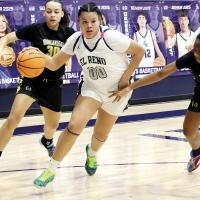 Lilly Thomas dribbles through two defenders en route to a shot attempt