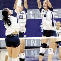Meredick Martinez (11) and Brantlie Charmasson (8) combine for a double block attempt