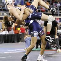 Foxx Kurtz tries to pull the wrist of Shawnee’s Kade Carter away from his chest while being lifted backward