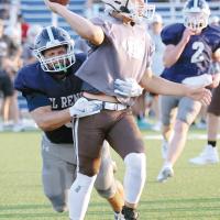 Grant First hits an Elk City quarterback as he throws on the run
