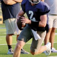 Rustyn Cook rolls out of the pocket on a pass play