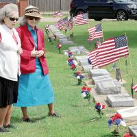 Barbara O’Neal and Vera Mae Morse look over the grave of a family member