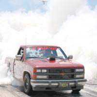 A Chevy pickup lives up to its license plate by leaving a large plume of smoke