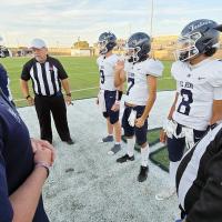 EHS football players await the coin toss