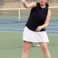 Serinity Billings hits an overhand return shot