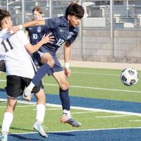 Vicente Saldana Barbosa jumps past a Westmoore player to get to the ball