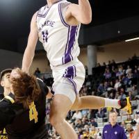 Jett Mueggenborg glances off a Caddo defender for an off-balanced layup
