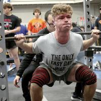 Tucker McDaniel grunts as he works to push up 395 pounds