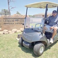 Kevin Armold shows off one of the 50 Yamaha gas golf carts