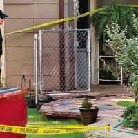 A law enforcement member looks over the area where a man was shot