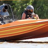 Matt Miller guides his bright orange Miller Time boat off the starting line