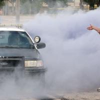 Sam Webster sends out a plume of purple smoke during the burnout