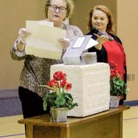 Dr. Kristy Ehlers opens the time capsule with Amy Neathery 