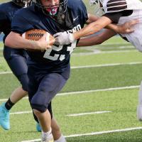Brent Parker pushes his way past a tackler