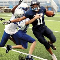 Kaleb Blackwolf runs through defenders for extra yards