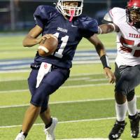 Kaleb Blackwolf (11) eludes a tackler