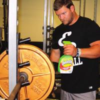 Austin Feddersen sprays down disks in the weight room
