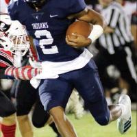 Above, El Reno quarterback Dorian Plumley breaks an arm tackle on a run in the third period. Tight end Kolton Hunt, top photo, tries to reach back and make a one-handed grab against Poteau. ( Tribune photographer/Glen Miller)
