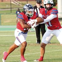 Malachi Nicholson takes a handoff from Jones quarterback Clayton Creasey