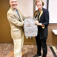 Todd Branson receives an OSU Extension bag from Damona Doye