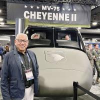 Gordon Yellowman stands in front of the Cheyenne II aircraft