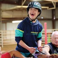 Alan Barbosa rides during a therapy session through Savannah Station