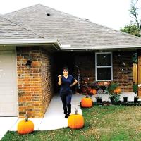 Ariana Orozco holds up the keys outside her new home