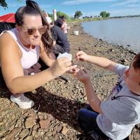 Bailey Gilbert helps her nephew, Brayton Jones put a worm on a hook