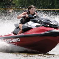Teagan Finnigan drives through a spray of water