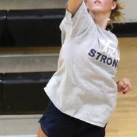 Bailey Denwalt serves during drills