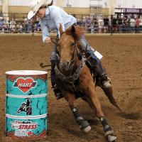 Darla Hoover leans into a turn during the barrel racing event