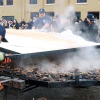 Members of the El Reno Fire Department roll out the top portion of the bun onto the Big Burger