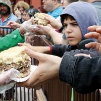 The crowd lines the barriers hoping to get a slice of the world’s largest fried onion burger